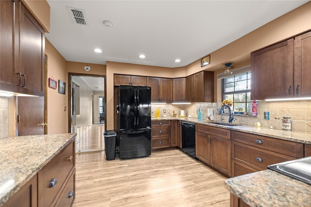6497 W Anthony Rd, Ocala, FL 34479 - kitchen with black appliances, a sink, tasteful backsplash, light wood-type flooring, and recessed lighting
