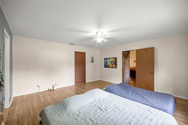 6497 W Anthony Rd, Ocala, FL 34479 - bedroom with baseboards, wood finished floors, and ceiling fan