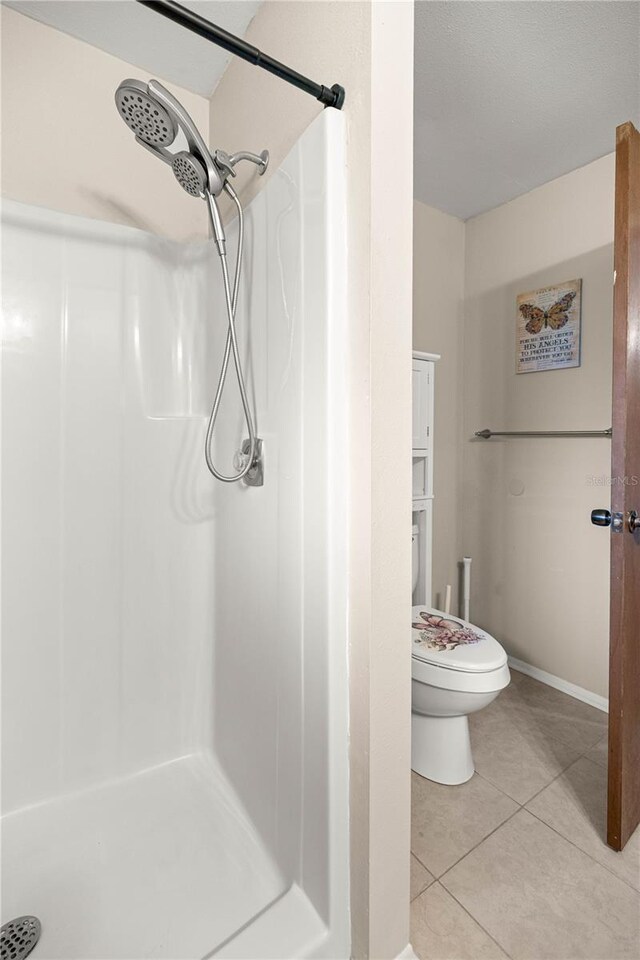 6497 W Anthony Rd, Ocala, FL 34479 - full bath featuring a stall shower, tile patterned flooring, and toilet