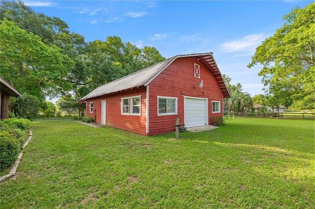 6497 W Anthony Rd, Ocala, FL 34479 - view of home's exterior featuring a garage and an outbuilding