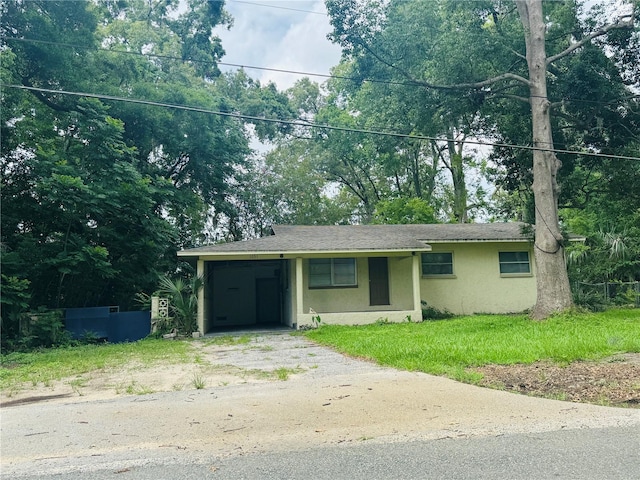 1051 SE 28th Rd, Ocala, FL 34471 - view of front of home with stucco siding, driveway, and a front yard