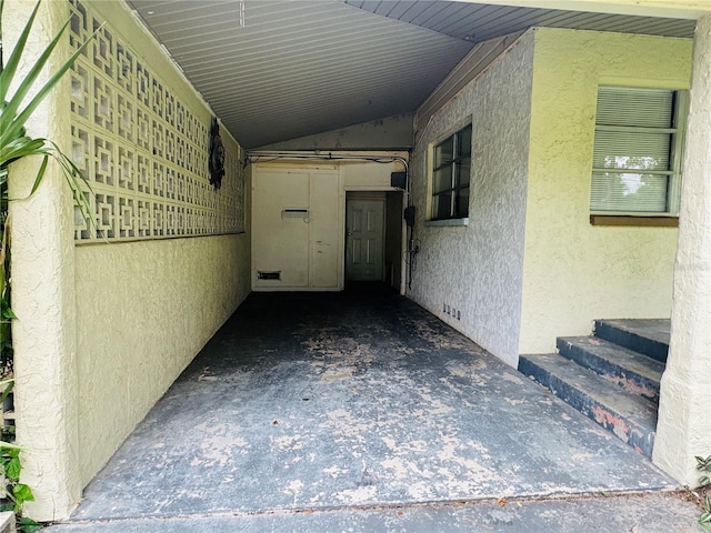 1051 SE 28th Rd, Ocala, FL 34471 - doorway to property featuring stucco siding and an attached carport