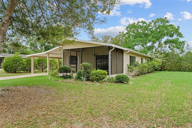 10012 SW 88th Ct, Ocala, FL 34481 - view of property exterior with a yard, an attached carport, and driveway