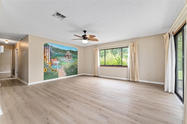 10012 SW 88th Ct, Ocala, FL 34481 - empty room featuring a textured ceiling, light wood finished floors, a ceiling fan, and plenty of natural light