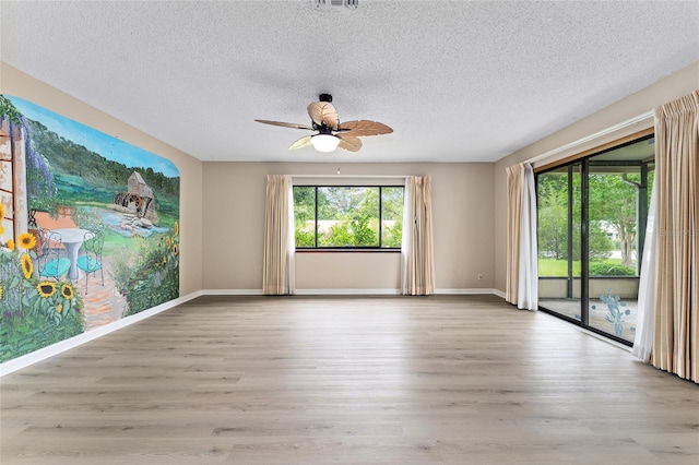 10012 SW 88th Ct, Ocala, FL 34481 - unfurnished room with wood finished floors, a ceiling fan, a textured ceiling, and baseboards