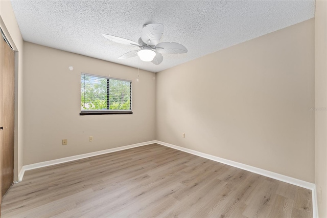 10012 SW 88th Ct, Ocala, FL 34481 - unfurnished bedroom with a closet, light wood-type flooring, a textured ceiling, baseboards, and a ceiling fan
