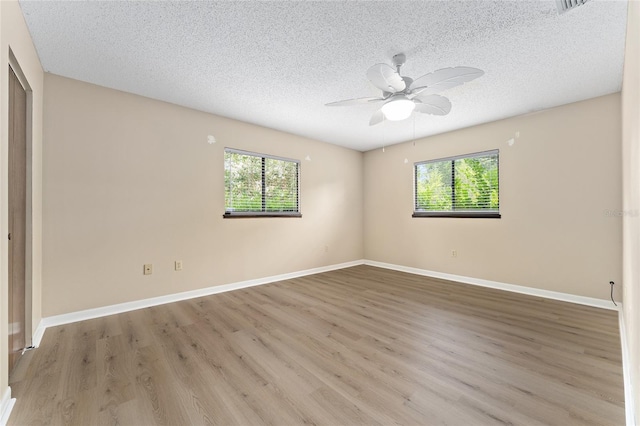 10012 SW 88th Ct, Ocala, FL 34481 - unfurnished room with plenty of natural light, a textured ceiling, wood finished floors, and a ceiling fan