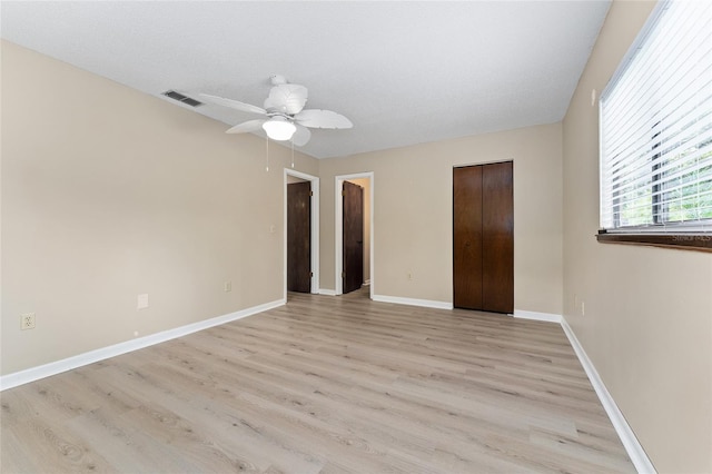 10012 SW 88th Ct, Ocala, FL 34481 - unfurnished bedroom featuring light wood finished floors, baseboards, ceiling fan, and a closet