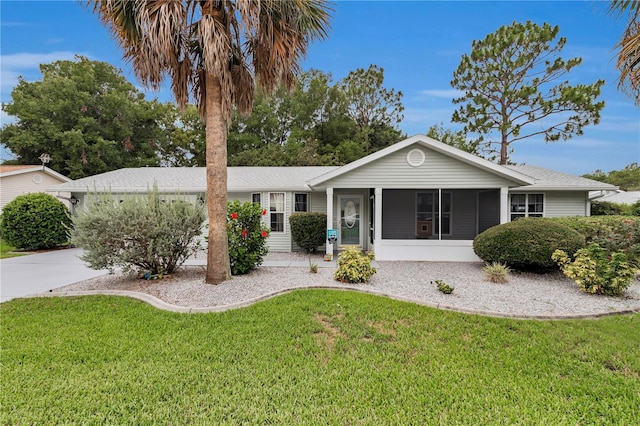 10806 SW 86th Ave, Ocala, FL 34481 - ranch-style home featuring a sunroom, a front lawn, and a shingled roof