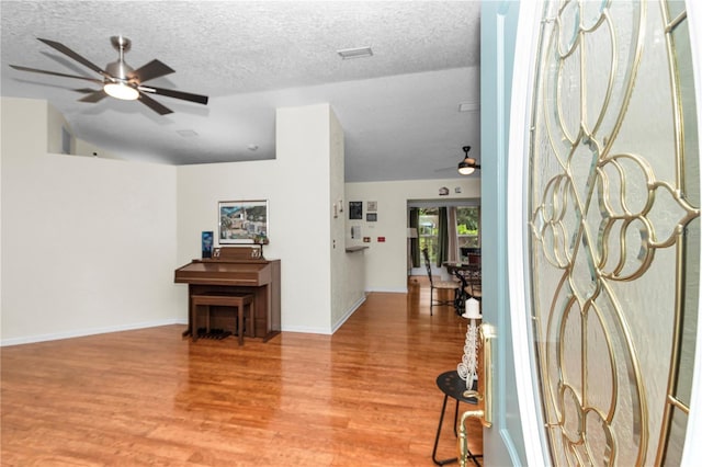 10806 SW 86th Ave, Ocala, FL 34481 - entrance foyer featuring ceiling fan, light wood-style floors, a textured ceiling, and baseboards