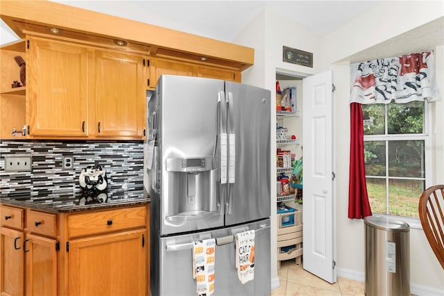 10806 SW 86th Ave, Ocala, FL 34481 - kitchen with stainless steel fridge, decorative backsplash, light tile patterned floors, open shelves, and dark stone counters