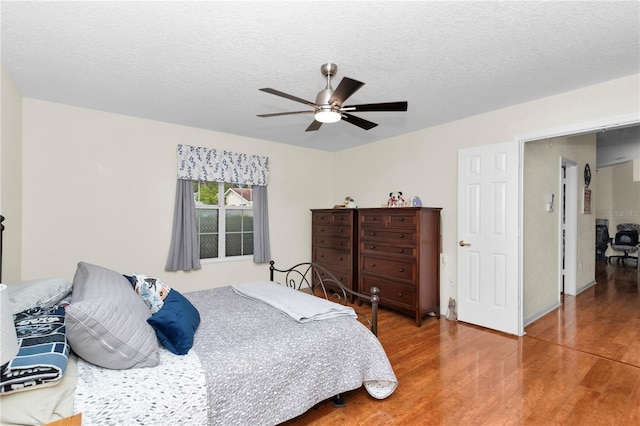 10806 SW 86th Ave, Ocala, FL 34481 - bedroom with wood finished floors, a textured ceiling, and a ceiling fan