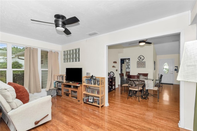 10806 SW 86th Ave, Ocala, FL 34481 - living area featuring a ceiling fan, light wood finished floors, and ornamental molding