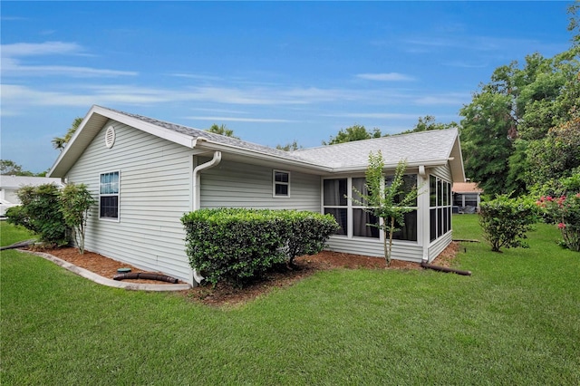 10806 SW 86th Ave, Ocala, FL 34481 - view of home's exterior featuring a sunroom, a lawn, and a shingled roof