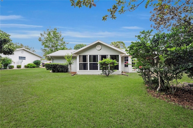 10806 SW 86th Ave, Ocala, FL 34481 - back of house with a lawn and a sunroom