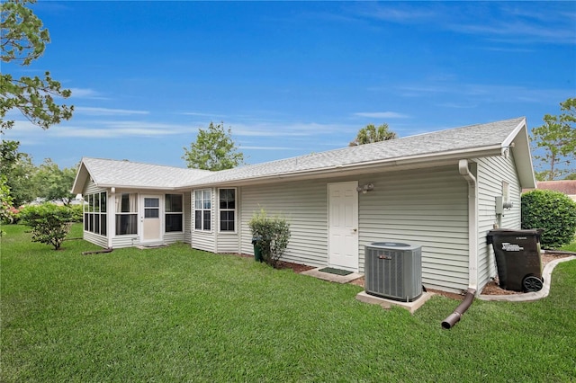 10806 SW 86th Ave, Ocala, FL 34481 - back of house with central AC unit, a yard, and a shingled roof