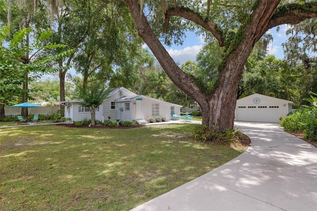 12335 SE 130th Ct, Ocklawaha, FL 32179 - view of front facade featuring a garage, a front lawn, and an outdoor structure