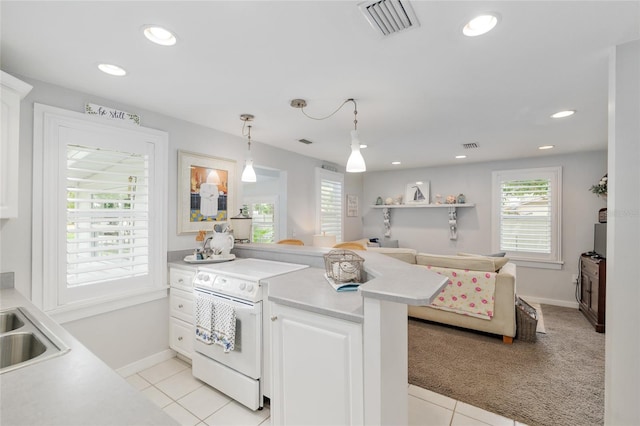 12335 SE 130th Ct, Ocklawaha, FL 32179 - kitchen featuring white range with electric stovetop, light countertops, white cabinets, a peninsula, and recessed lighting