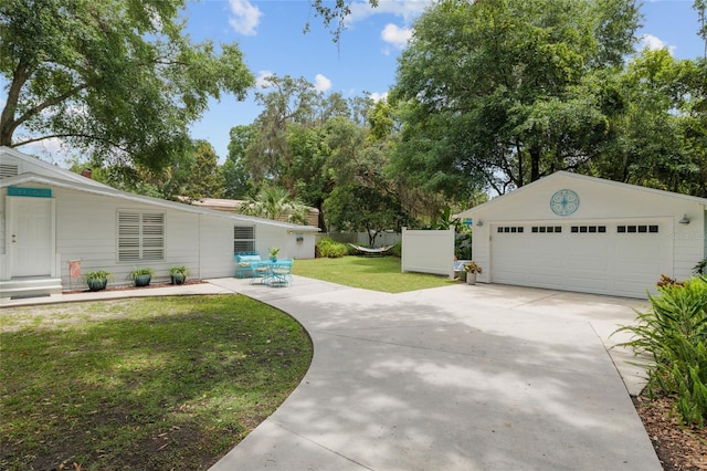 12335 SE 130th Ct, Ocklawaha, FL 32179 - view of green lawn featuring a detached garage