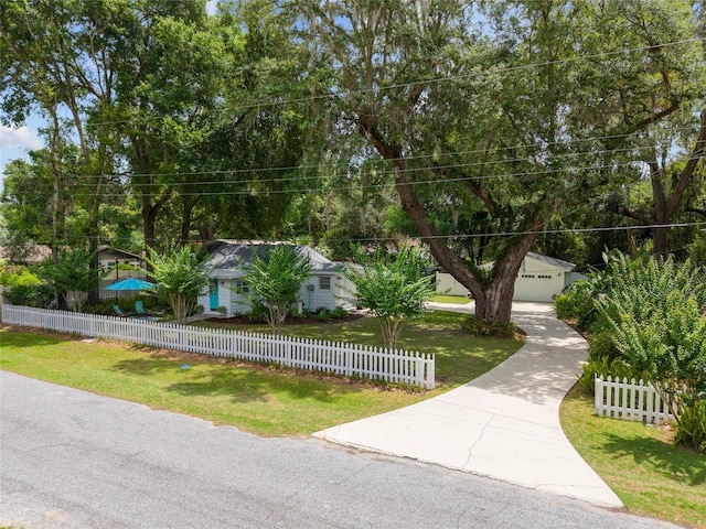 12335 SE 130th Ct, Ocklawaha, FL 32179 - view of property hidden behind natural elements featuring a garage and driveway
