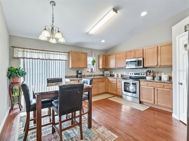 11 Pecan Course Loop, Ocala, FL 34472 - kitchen featuring stainless steel appliances, light brown cabinets, light wood-style flooring, vaulted ceiling, and recessed lighting
