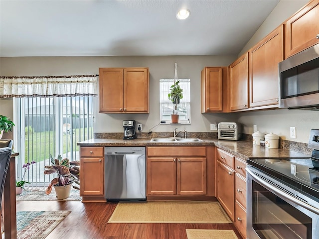 11 Pecan Course Loop, Ocala, FL 34472 - kitchen featuring stainless steel appliances, a sink, light wood-style floors, and dark countertops