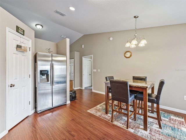 11 Pecan Course Loop, Ocala, FL 34472 - dining space with lofted ceiling, wood finished floors, a chandelier, and baseboards