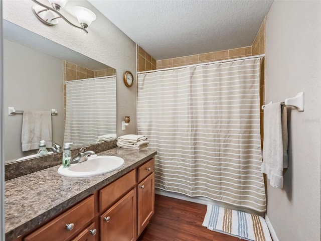 11 Pecan Course Loop, Ocala, FL 34472 - full bath featuring a textured ceiling, vanity, wood finished floors, and a shower with shower curtain