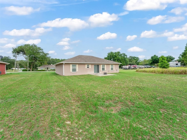 11 Pecan Course Loop, Ocala, FL 34472 - rear view of property featuring a yard, a patio, and stucco siding