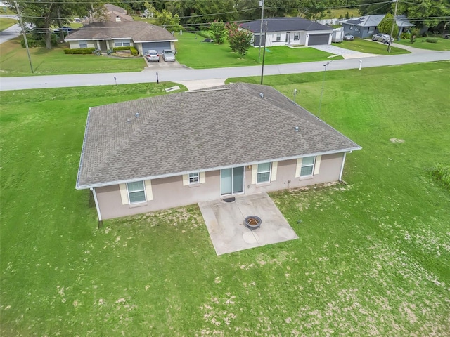 11 Pecan Course Loop, Ocala, FL 34472 - back of property with stucco siding, a yard, a garage, roof with shingles, and a patio
