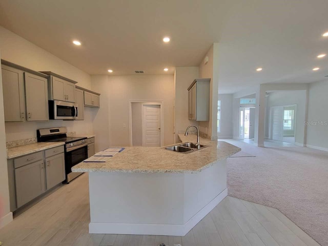 15055 SW 25th Cir, Ocala, FL 34473 - kitchen with a sink, stainless steel appliances, gray cabinetry, light countertops, and recessed lighting