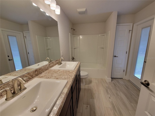 15055 SW 25th Cir, Ocala, FL 34473 - full bath with double vanity, wood finished floors, toilet, and washtub / shower combination
