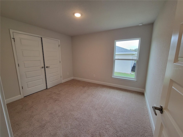 15055 SW 25th Cir, Ocala, FL 34473 - unfurnished bedroom featuring carpet flooring, baseboards, and a closet