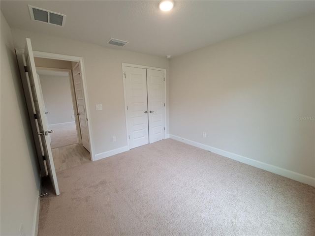 15055 SW 25th Cir, Ocala, FL 34473 - unfurnished bedroom with light carpet, a closet, and baseboards