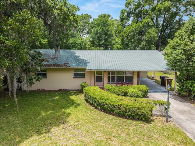 3621 SE 12th Pl, Ocala, FL 34471 - ranch-style home with asphalt driveway, concrete block siding, a front lawn, a carport, and metal roof