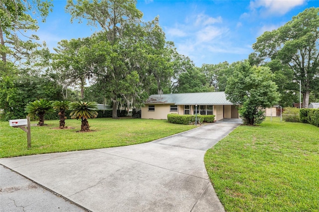 3621 SE 12th Pl, Ocala, FL 34471 - single story home featuring driveway, a carport, and metal roof