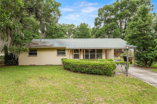 3621 SE 12th Pl, Ocala, FL 34471 - ranch-style house featuring a front lawn, driveway, and metal roof