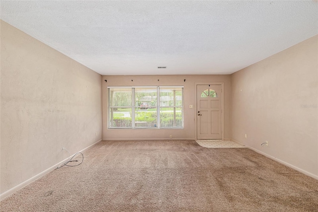 3621 SE 12th Pl, Ocala, FL 34471 - empty room featuring carpet, a textured ceiling, and baseboards