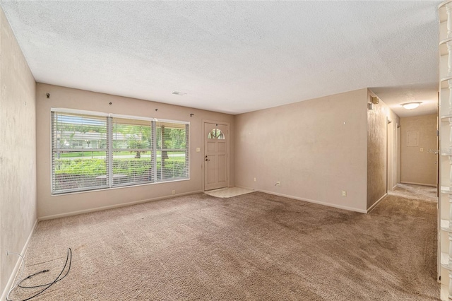 3621 SE 12th Pl, Ocala, FL 34471 - unfurnished room featuring a textured ceiling, carpet, and baseboards