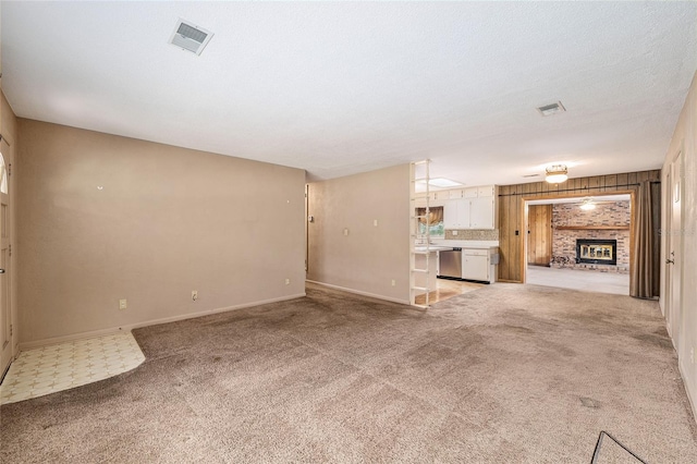 3621 SE 12th Pl, Ocala, FL 34471 - unfurnished living room with light carpet, baseboards, and a fireplace