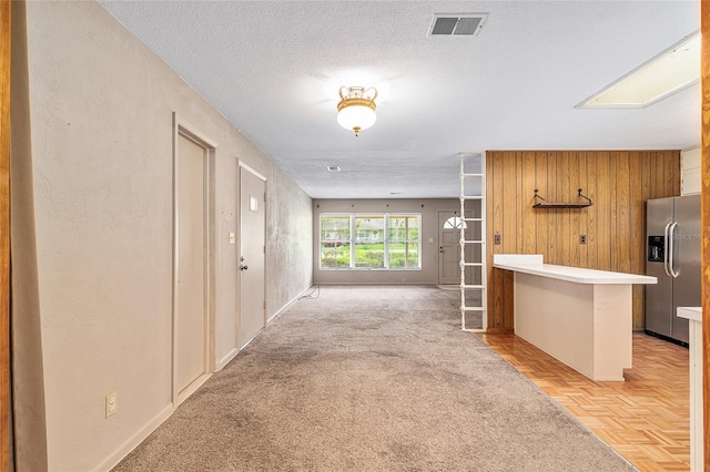 3621 SE 12th Pl, Ocala, FL 34471 - hall with wooden walls, baseboards, and a textured ceiling