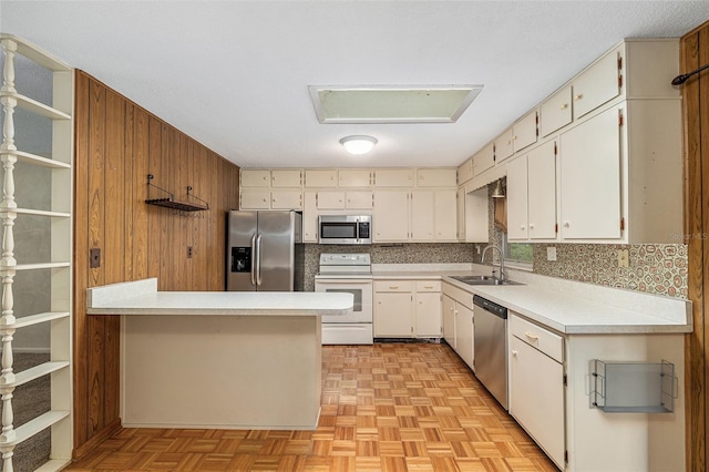 3621 SE 12th Pl, Ocala, FL 34471 - kitchen featuring appliances with stainless steel finishes, a sink, light countertops, a peninsula, and open shelves