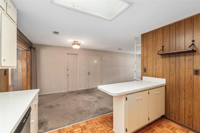 3621 SE 12th Pl, Ocala, FL 34471 - kitchen with a peninsula, light countertops, open floor plan, stainless steel dishwasher, and wood walls