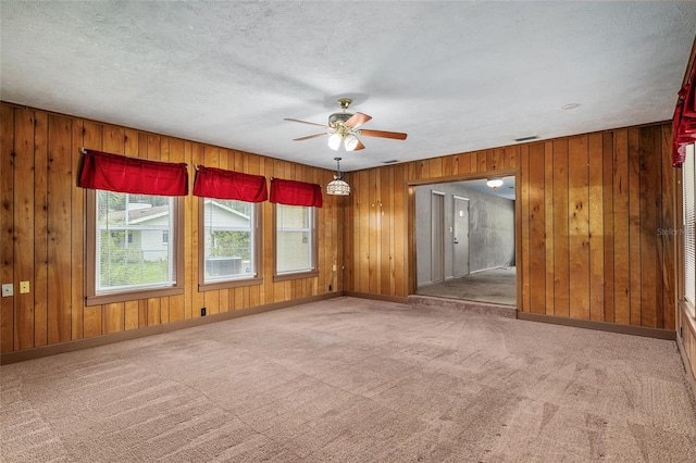 3621 SE 12th Pl, Ocala, FL 34471 - carpeted spare room with ceiling fan, wooden walls, and baseboards