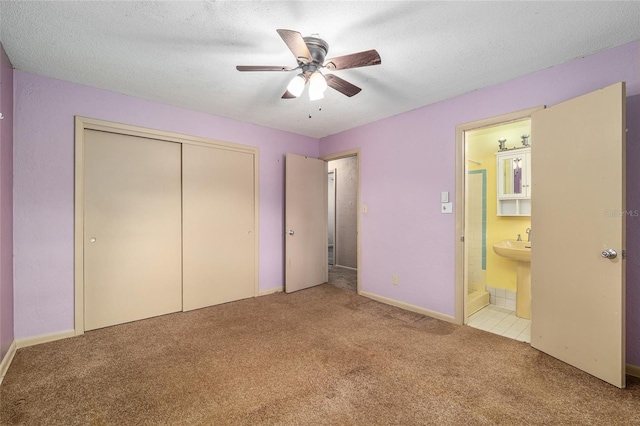 3621 SE 12th Pl, Ocala, FL 34471 - unfurnished bedroom featuring carpet flooring, a closet, ensuite bathroom, a sink, and a ceiling fan