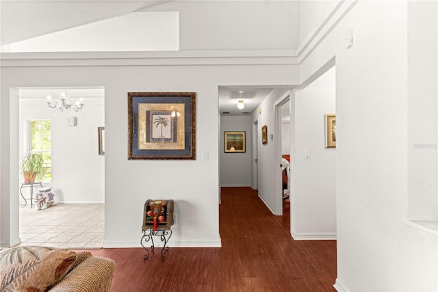 5445 NE Anthony Rd, Ocala, FL 34475 - hall featuring wood finished floors, baseboards, and a chandelier