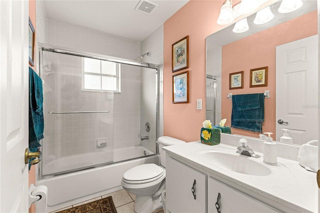 5445 NE Anthony Rd, Ocala, FL 34475 - full bathroom featuring vanity, toilet, shower / bath combination with glass door, and tile patterned flooring