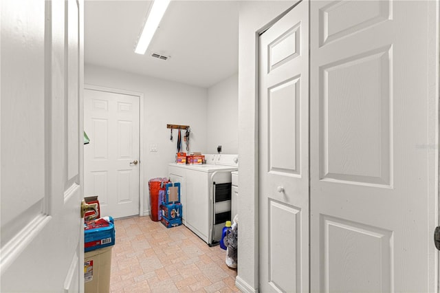 5445 NE Anthony Rd, Ocala, FL 34475 - washroom with brick patterned flooring and washing machine and dryer