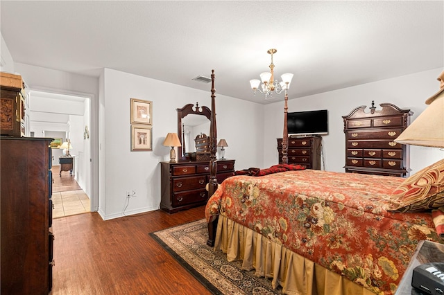 5445 NE Anthony Rd, Ocala, FL 34475 - bedroom with a chandelier, wood finished floors, and baseboards