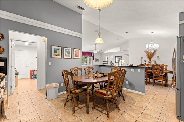 5445 NE Anthony Rd, Ocala, FL 34475 - dining room featuring light tile patterned flooring, lofted ceiling, ceiling fan, a chandelier, and baseboards